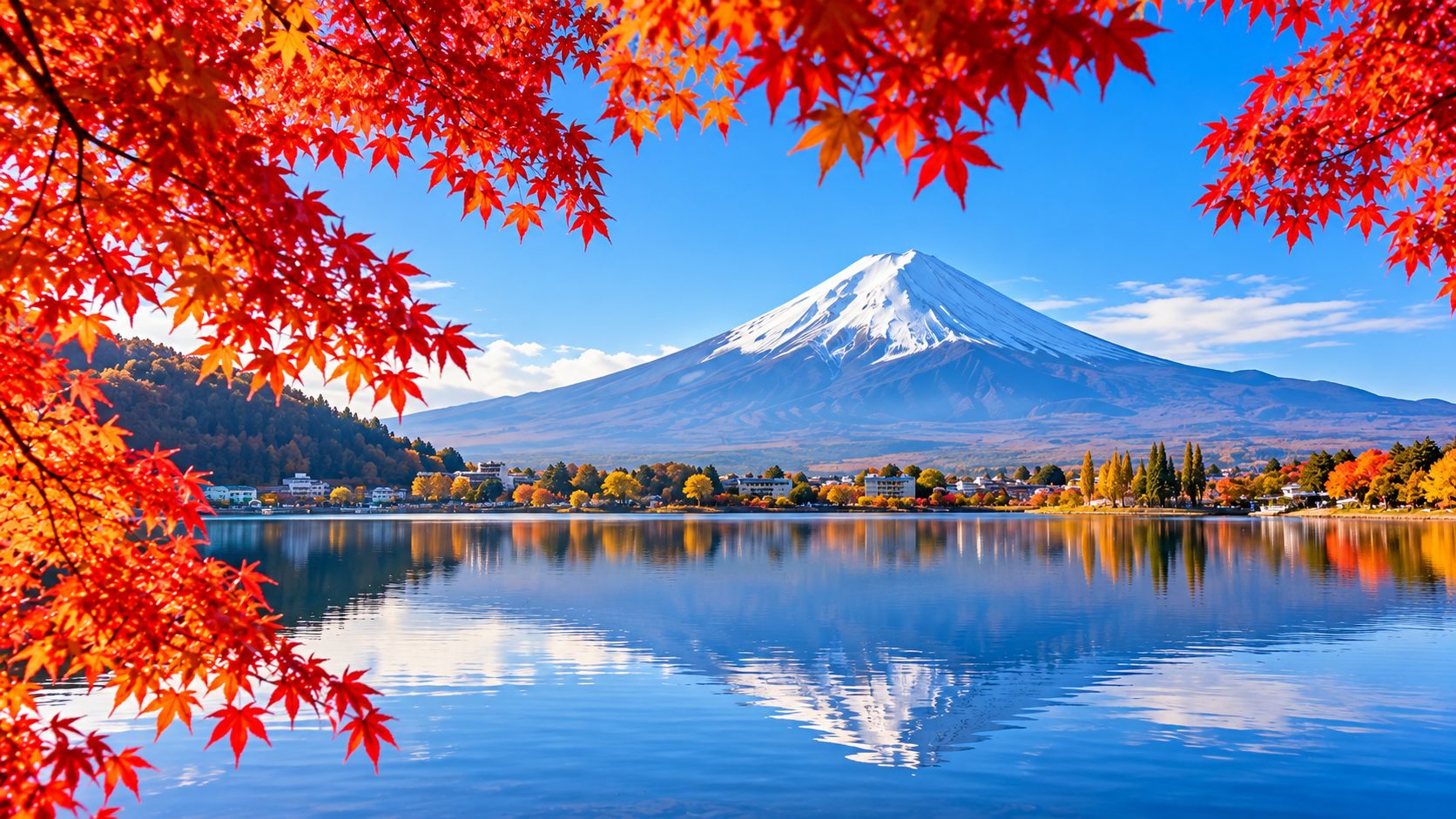 Mt Fuji above Lake Kawaguchi framed by red autumn maples
